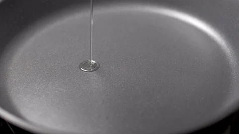 Chef putting vegetable oil to pan Stock Footage 103574336
