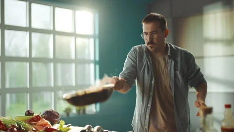 Chef putting vegetables into pan Stock Footage 311834967