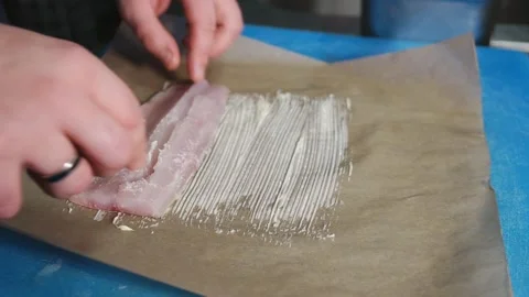 Chef putting white fish fillet on butter on Parchment Paper to bake Stock Footage 222217187