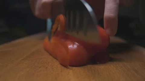 Chef quickly cuts red peppers on a wooden board Stock Footage 141260851