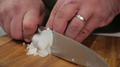 Chef quickly slices the onion with a sharp knife. close-up of a man's hands  Stock Footage 163971321