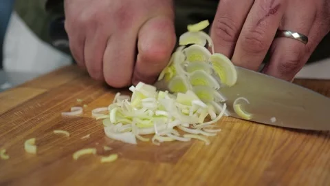 Chef quickly slices the onion with a sharp knife. close-up of a man's hands  Stock Footage 163971411