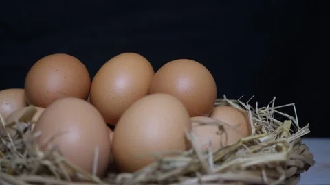 The chef is reaching out to pick up 1 egg in a basket full of them Stock Footage 160533225