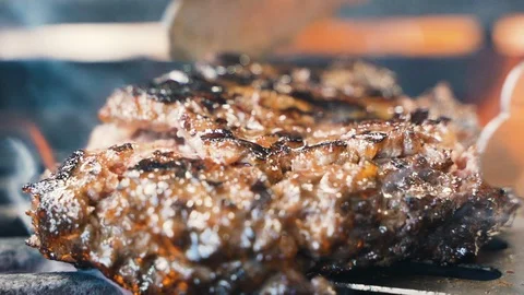 Chef removes beef or pork hamburger meatballs from the grill, barbecue Stockbeeldmateriaal 107534748