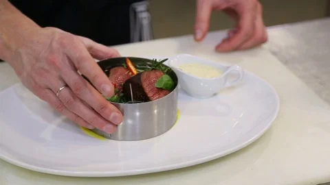 The chef removes the culinary form from the finished dish Stock Footage 129572416