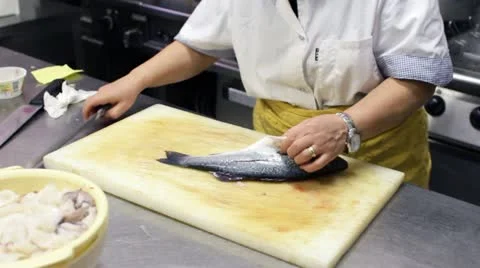 Chef Removes the pin bones from fish Stock Footage 21426582