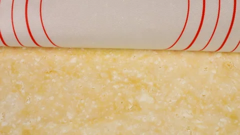 The chef removes a silicone baking mat from a smooth cottage cheese dough. Stock Footage 341513194