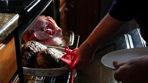 Chef removing a pan with meat roast from the oven Stock Footage 150477999