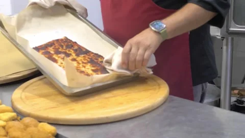 Chef removing thick pizza with tomato sauce and mozzarella from oven Stock Footage 340153600