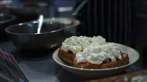 The chef in the restaurant kitchen decorates the bruschetta with tongs, tweezers Stock Footage 141790834
