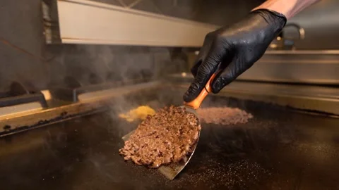 Chef in restaurant kitchen making burger. Fresh meat twisted into minced meat Stock Footage 262449925