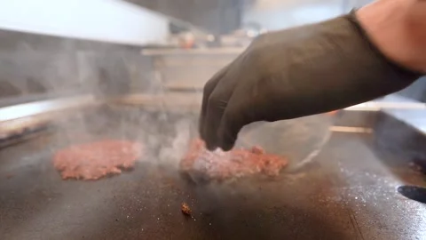 Chef in restaurant kitchen making burger. Fresh meat twisted into minced meat Stock Footage 262450260