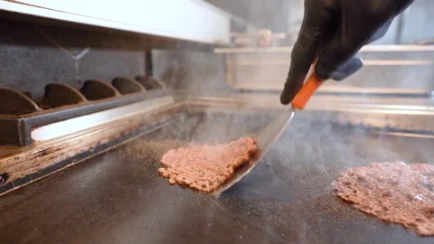 Chef in restaurant kitchen making burger. Fresh meat twisted into minced meat Stock Footage 262450656