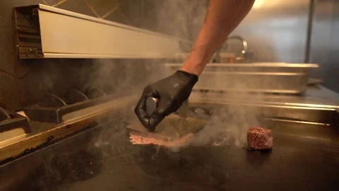 Chef in restaurant kitchen making burger. Fresh meat twisted into minced meat Stock Footage 262553002