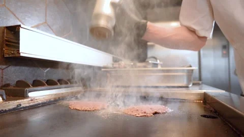 Chef in restaurant kitchen making burger. Fresh meat twisted into minced meat Stock Footage 262553840
