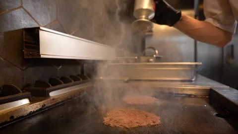 Chef in restaurant kitchen making burger. Fresh meat twisted into minced meat Stock Footage 262557549