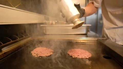 Chef in restaurant kitchen making burger. Fresh meat twisted into minced meat Stock Footage 262558056