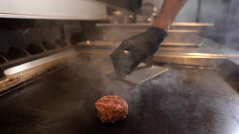 Chef in restaurant kitchen making burger. Fresh meat twisted into minced meat Stock Footage 262560643