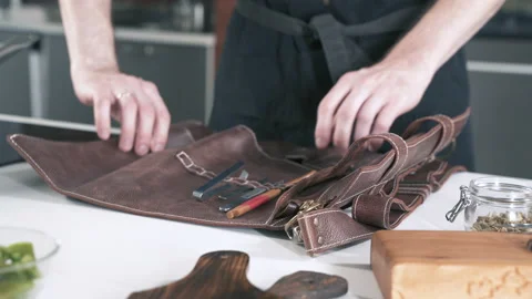 Chef In Restaurant Kitchen Puts Knives and Tools On Table Before Cooking Food. Stock-Footage 142806893