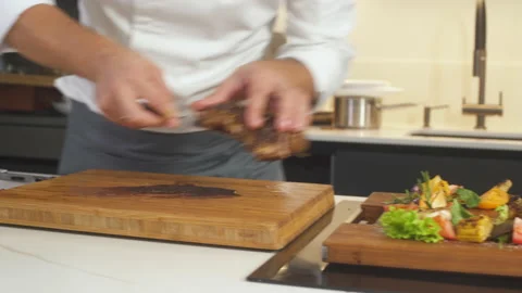 Chef At Restaurant Kitchen Serves Grilled Steak Platter Preparing Delicious Food 動画素材 142819503
