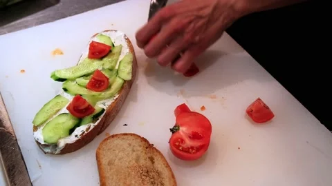 The chef in the restaurant makes a sandwich with vegetables. Proper healthy Video stock 171592848
