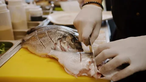 Chef in a restaurant prepares fish Stock Footage 143392711