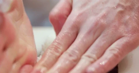 Chef in restaurant preparing and Cutting sushi rolls healthy food  Stock Footage 58058624