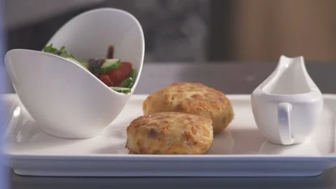 The chef of restaurant serves a dish of meatballs and vegetable. Stock Footage 89058751