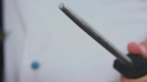 Chef at restaurant sharpening knife on grindstone Stock Footage 82470625