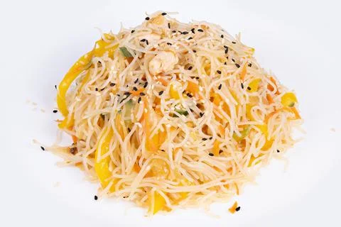 Chef rice vermicelli presentation with thin yellow pepper strips and sesame.. Stock Photos