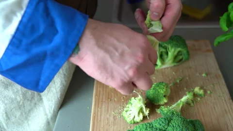 Chef ripping broccoli by hands slowmo Stock Footage 161160792