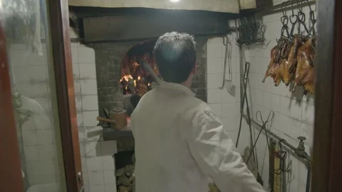 Chef Roasting Poultry Over Wood Fire in Traditional Beijing Restaurant Kitchen Stock Footage 345773420