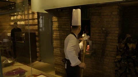 Chef Roasting Poultry in Wood-Fired Oven at Restaurant Kitchen in Beijing, China Stock Footage 345783248