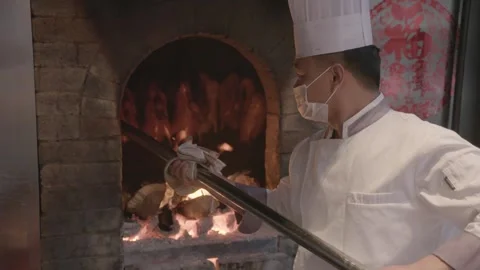 Chef Roasting Poultry in Wood-Fired Oven at Restaurant Kitchen in Beijing, China Stock Footage 345854600