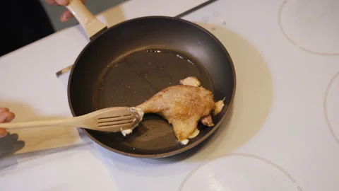 Chef roasting raw chicken in frying pan close up Video stock 104394086