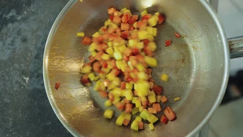Chef roasts and mixes vegetables in a hot pan, vegetarian dish Stock Footage 113627398