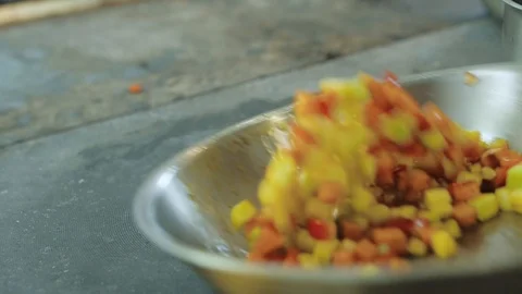 Chef roasts and mixes vegetables in a hot pan, vegetarian dish Stock Footage 113627461
