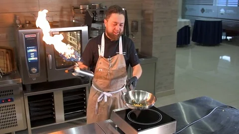 Chef roasts chopped pumpkin Stock Footage 97880872