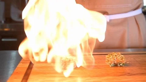 Chef roasts the fish burner Stock Footage 97881098