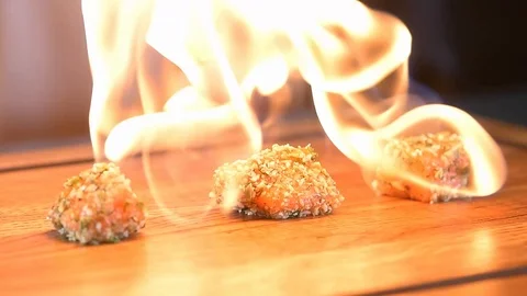 Chef roasts the fish burner Stock Footage 97881101