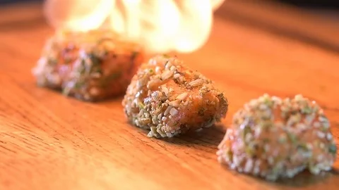 Chef roasts the fish burner Stock Footage 97881120