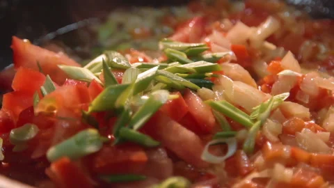 The chef roasts the onion and bell pepper in a frying pan and adds green onions Stock Footage 158021746