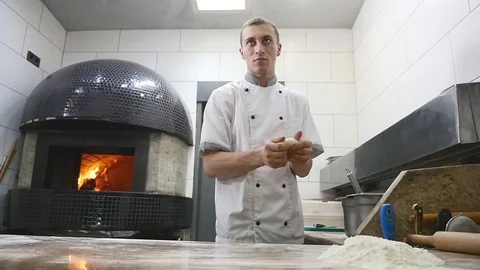 The chef roll the dough into pizza Stock Footage 77350102