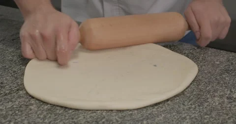 Chef roll out dough with a rolling pin, preparing pasta or phyllo dough. Close Stock Footage 293840297