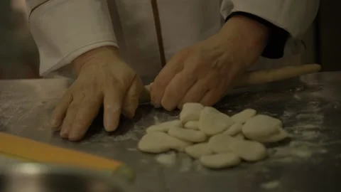 Chef Rolling Dough by Hand on Floured Surface in Beijing Street Food Kitchen Stock Footage 345880674