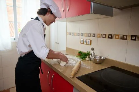 Chef Rolling Dough In Modern Kitchen Preparing Fresh Pastry For Cooking Class Stock Photos