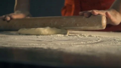 Chef rolling dough for pizza. Slow Motion Stock Footage 74446670