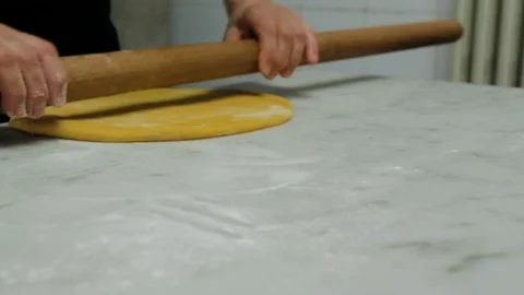 Chef rolling dough with rolling pin in kitchen Stock Footage 107569034