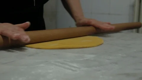 Chef rolling dough with rolling pin in kitchen Stock Footage 107569050
