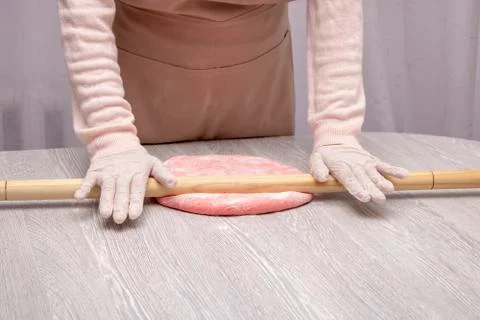Chef rolling dough with rolling-pin. Hands, horizontal Stock Photos